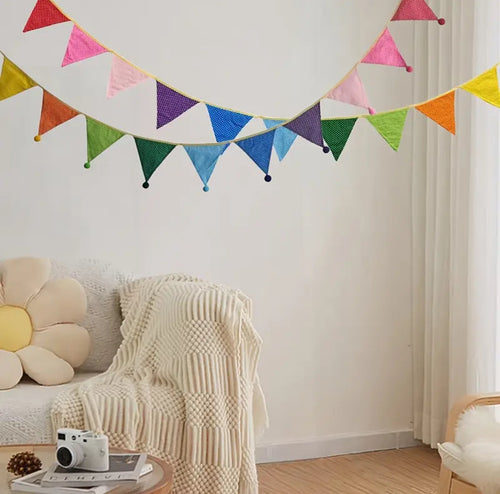 Bright multicoloured bunting with pom poms