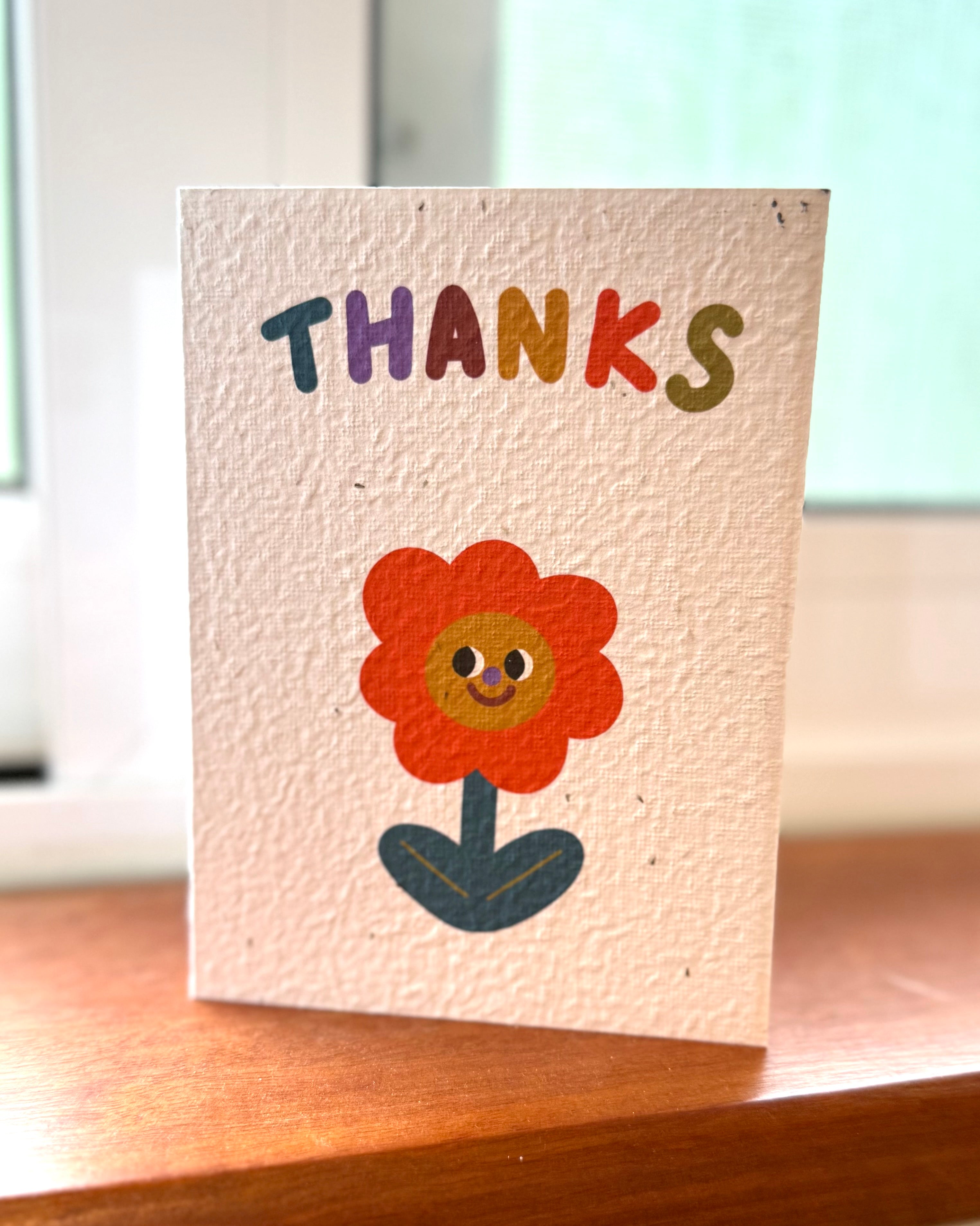 Seeded thank you card with a cute flower character illustration on it 