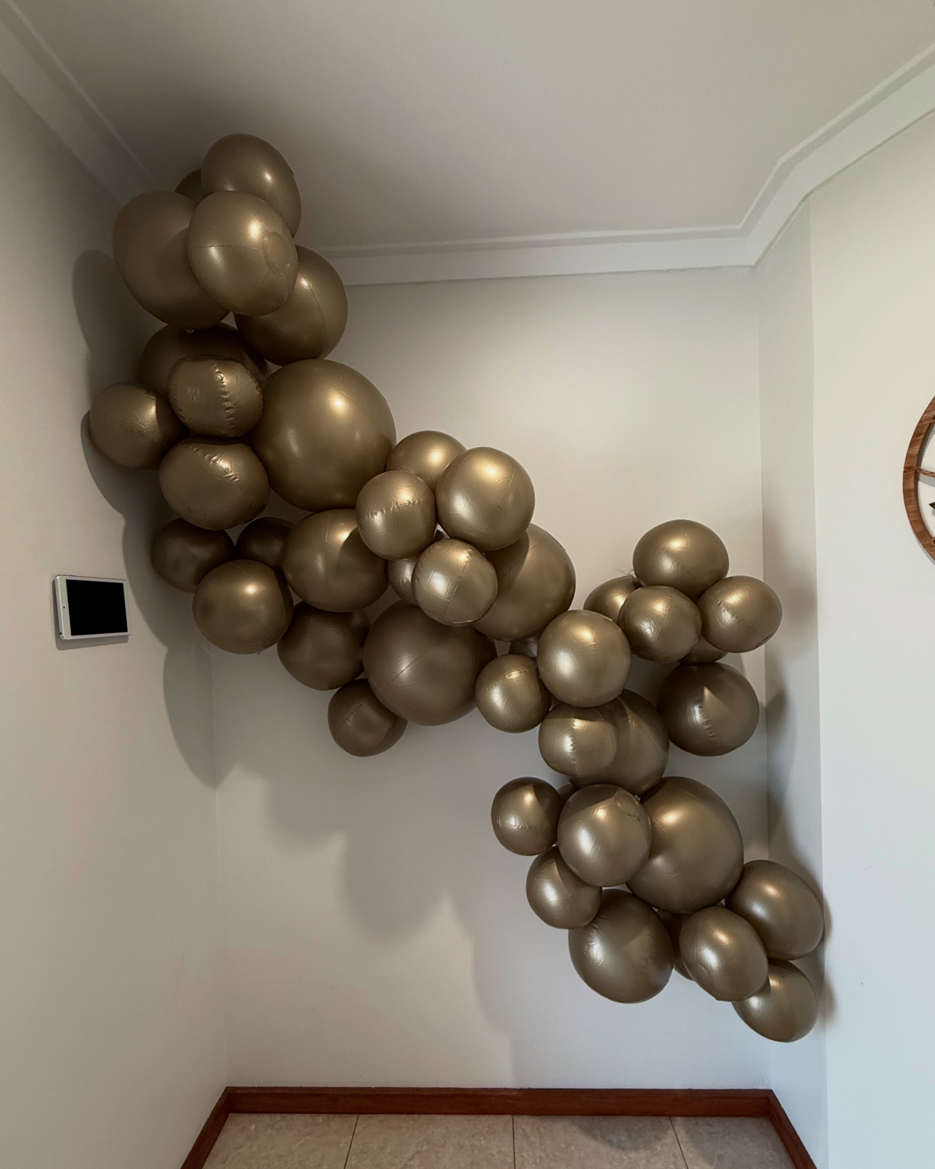 Eco-friendly balloon garland decor in gold by Evergarland at a 21st birthday party, reusable event decoration