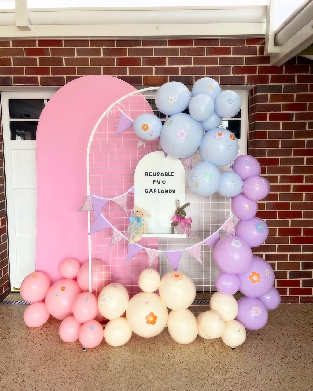 Reusable Evergarland balloon garlands in pastel pink, pastel blue, and pastel purple decorating a kids’ birthday party, eco-friendly party inspiration