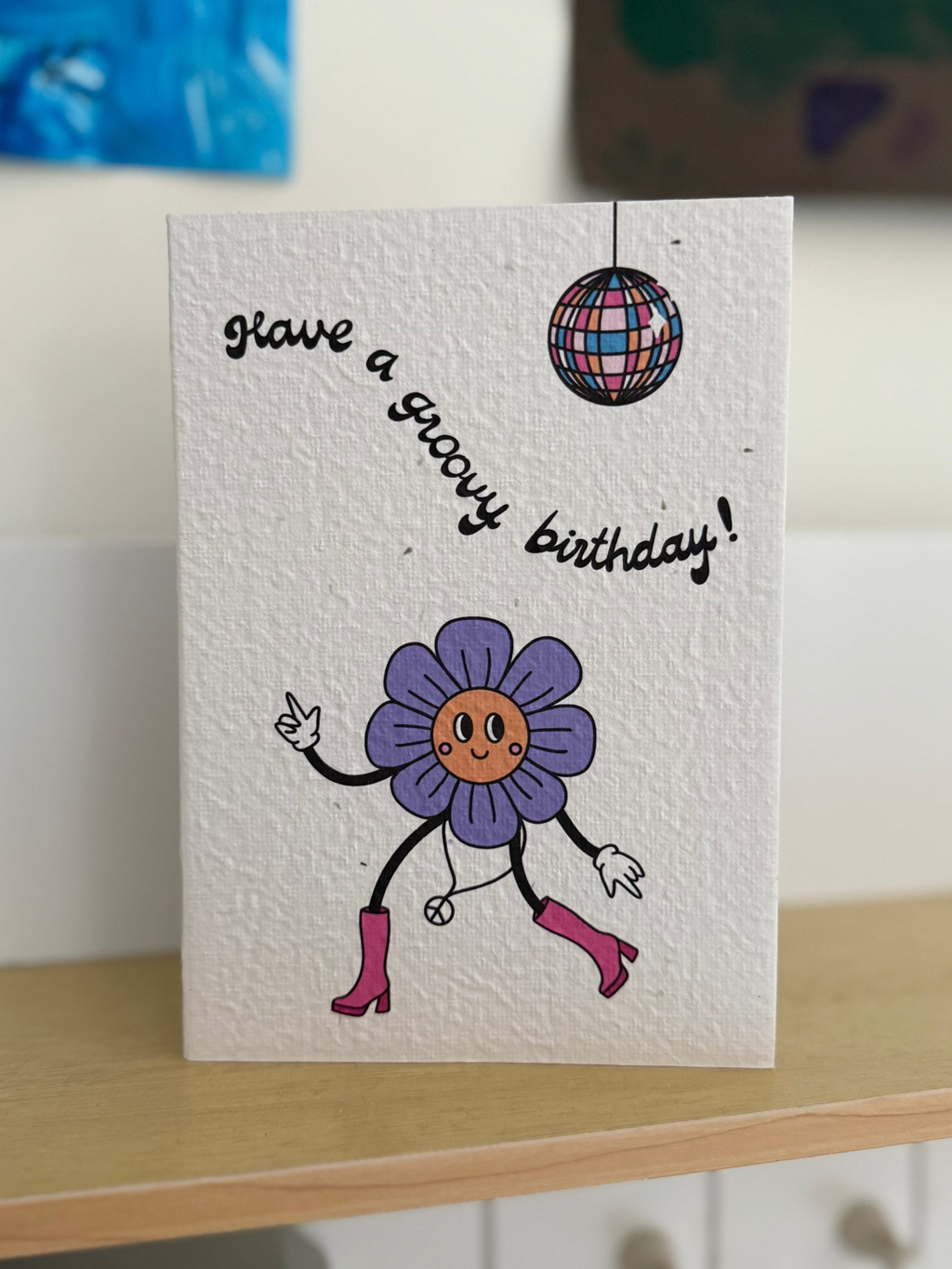 Plantable Greeting card with a groovy purple flower character dancing and disco ball on a shelf.
