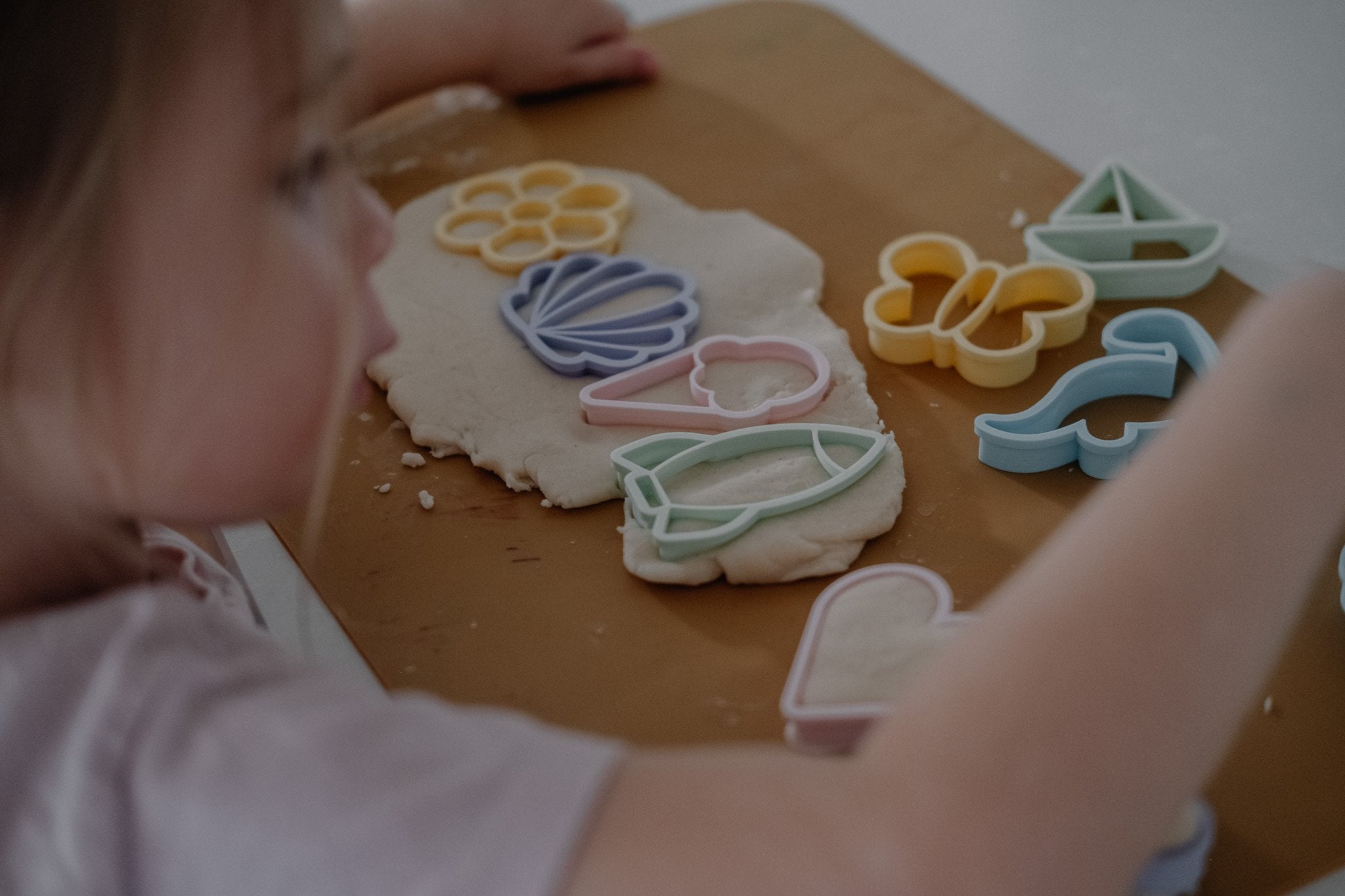 A little girl playing with kinfolk pantry assorted eco cutters and playdough, perfect for eco party favours